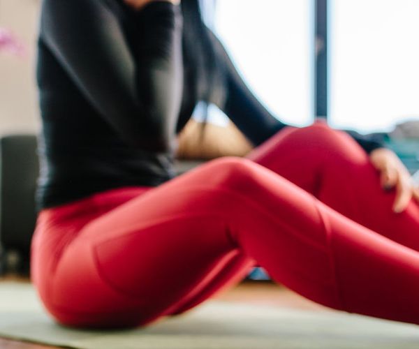 Person marking a calendar with a bright green marker next to a yoga mat.